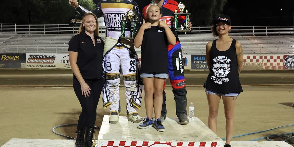 Aug 8 2025 – Championship racing begins at Fast Friday’s Motorcycle Speedway in Auburn, CA – 1977 Nicol Podium Broc Nicol (left back) and Greg Moore (back right) celebrate their wins Friday night, Nicol (the scratch main and Moore the handicap main) with Fast Friday's trophy girls (left-right) Kelly Craven, Lily Sneed and Leni Crow. Aug 8 2025 - Championship racing begins at Fast Friday’s Motorcycle Speedway in Auburn, CA.