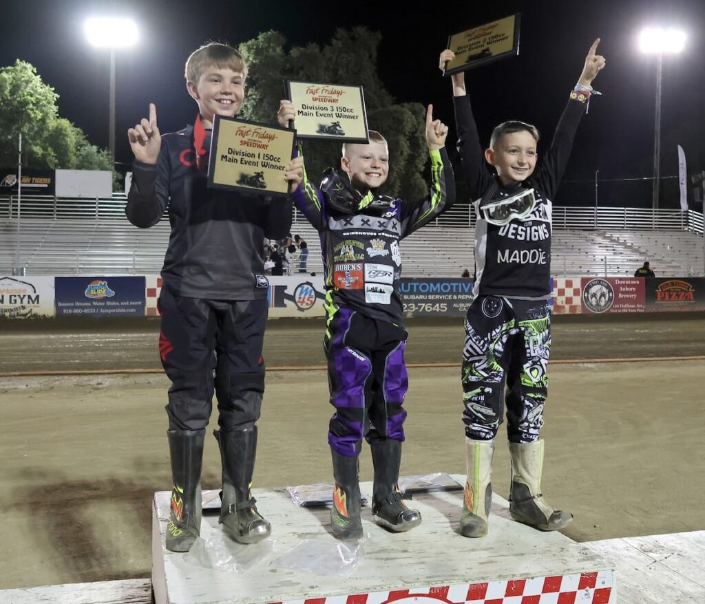 Celebrating their Youth 150 main event wins on the Fast Fridays winner's podium (left-right) D1 winner Mason Howell, D3 winner Luke Seeger and D2 winner Ryder Faria. Jun 19 2026 - 2026 Speedway & Legends & Vintage Night.