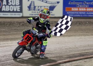 Dexter Orlando takes a lap holding the checkered flag after a pee-wee race. June 5 2026 - 2026 Speedway & Extreme Sidecars Round #1.