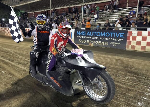 Wade Boyd and Joshua Bustos celebrate their sidecar main event win Friday night with a trip around the track with the checkered flag. June 5 2026 - 2026 Speedway & Extreme Sidecars Round #1.