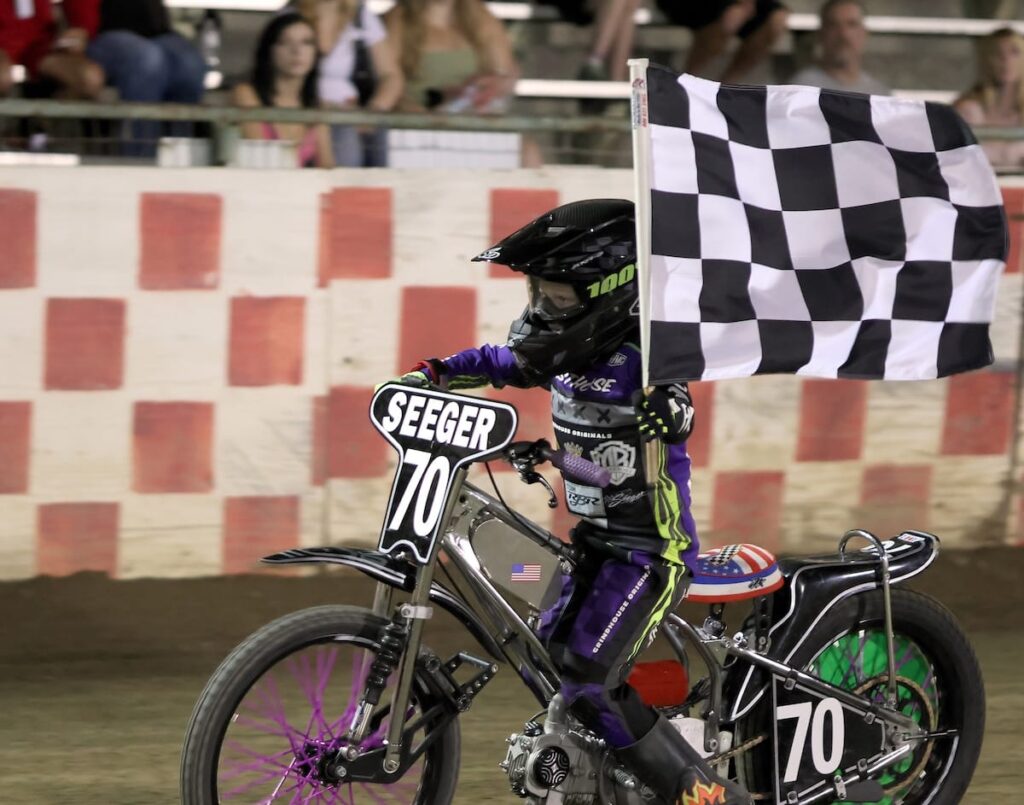 Luke Seeger takes a victory lap after winning the Youth 150cc D2 main event. The win was his fifth main event win of the season. July 10 2026 - 2026 Speedway & Team Challenge Round #4.