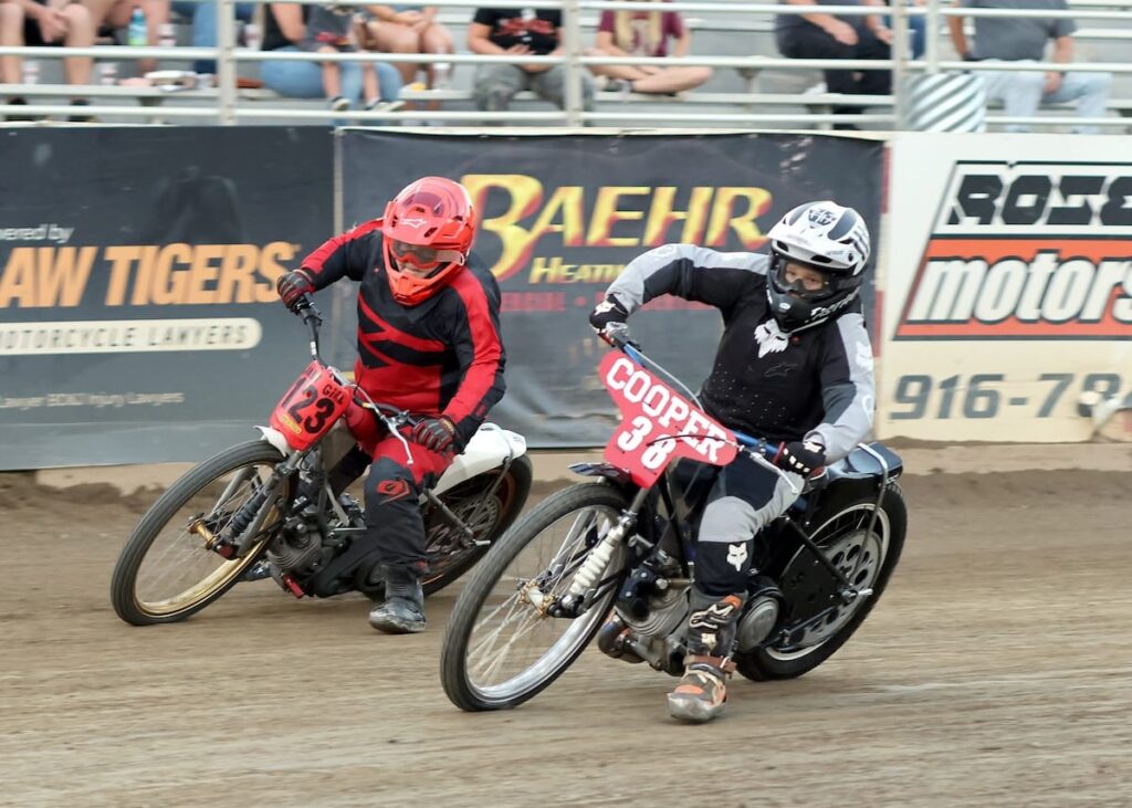 Tough competitors Leeann Emerson (left) and Colton Cooper duke it out in the Youth 250cc D2 main event race. Emerson won the main event, Cooper was second. July 17 2026 - 2026 Budweiser’s North vs. South Challenge.