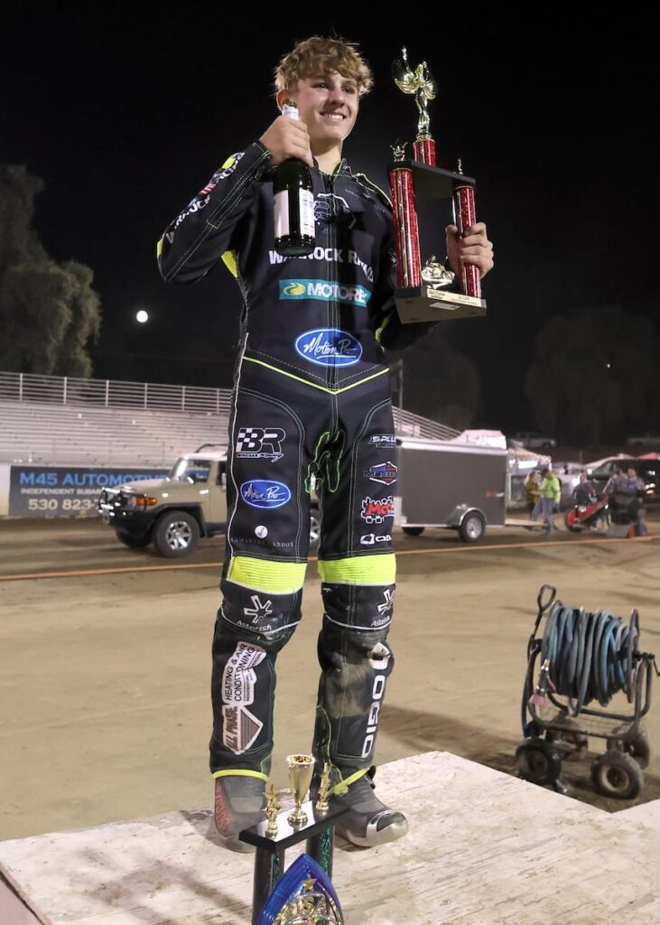 Brady Landon stands on the Fast Fridays winner's podium after winning the 25-lap handicap race and the scratch main event. July 31 2026 - 2026 Speedway & 25 Lap Main Event.