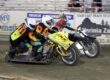 Robert and Laurie Curry (near) and Wade Boyd and Eric Lindauer race in a heat race Saturday night at Fast Friday's Motorcycle Speedway. The Curry team suffered mechanical difficulties in early heat races but won the sidecar main event. Aug 29 2026 - 2026 Speedway & Extreme Sidecars Round #4.