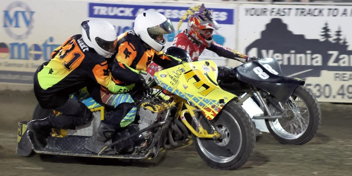Aug 29 2026 – 2026 Speedway & Extreme Sidecars Round #4 – 1473 Curry-Boyd Robert and Laurie Curry (near) and Wade Boyd and Eric Lindauer race in a heat race Saturday night at Fast Friday's Motorcycle Speedway. The Curry team suffered mechanical difficulties in early heat races but won the sidecar main event. Aug 29 2026 - 2026 Speedway & Extreme Sidecars Round #4.