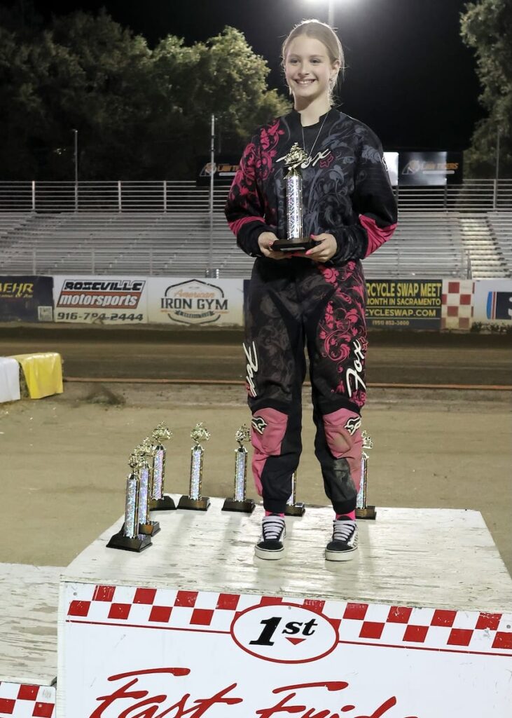 All smiles, Kaydence Craw is awarded her trophy for winning the Youth 150cc D3 main event. Aug 29 2026 - 2026 Speedway & Extreme Sidecars Round #4.